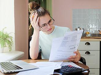 An upset women looking at paperwork